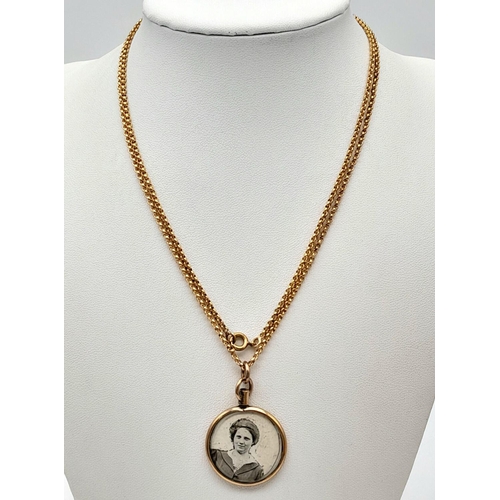 696 - A 9K Gold Picture Pendant on a Gilded Chain.