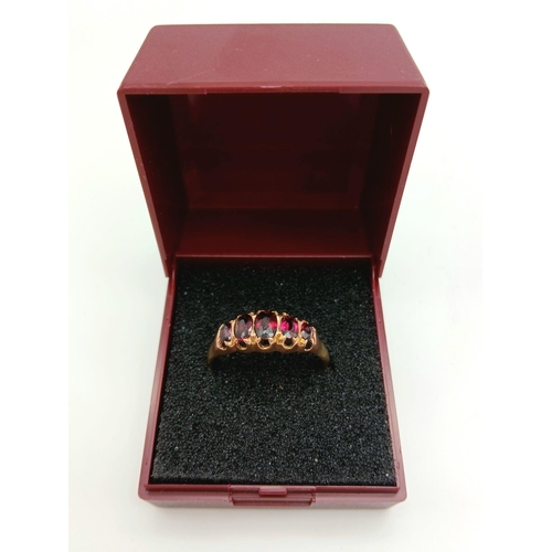 728 - Impressive 9 carat GOLD RING having 5 x RED GEMSTONES oval cut and Mounted to top. Complete with rin... 