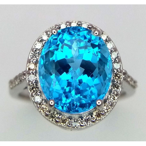 1561 - A 5ct Oval-cut Blue Topaz Ring surrounded by halo of 0.60ct diamonds accent. Set in 925 Silver. Ring... 