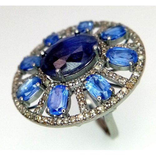 1109 - A 7.25ct Blue Sapphire ring, set in an elegant oval design with 4.70ct Kyanite stones arranged in a ... 