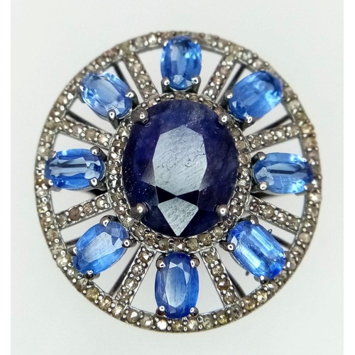 1109 - A 7.25ct Blue Sapphire ring, set in an elegant oval design with 4.70ct Kyanite stones arranged in a ... 