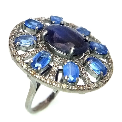 1109 - A 7.25ct Blue Sapphire ring, set in an elegant oval design with 4.70ct Kyanite stones arranged in a ... 