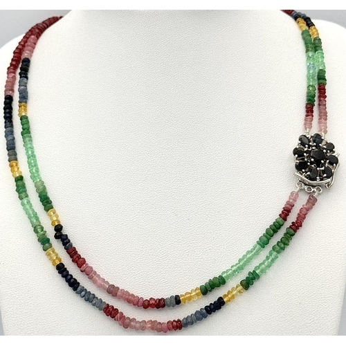 1438 - A vibrant multi gemstone necklace featuring Blue and Yellow Sapphires, Rubies, and Emerald beads, to... 