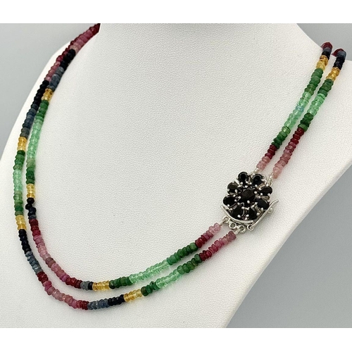 1438 - A vibrant multi gemstone necklace featuring Blue and Yellow Sapphires, Rubies, and Emerald beads, to... 