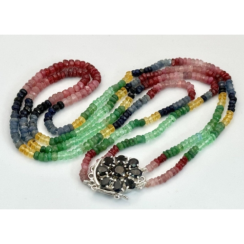 1438 - A vibrant multi gemstone necklace featuring Blue and Yellow Sapphires, Rubies, and Emerald beads, to... 