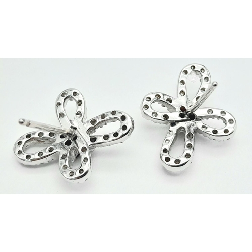 1168 - An Pair of 18K White Gold, Ruby and Diamond Floral Shape Earrings. No backs. 3.63g total weight.