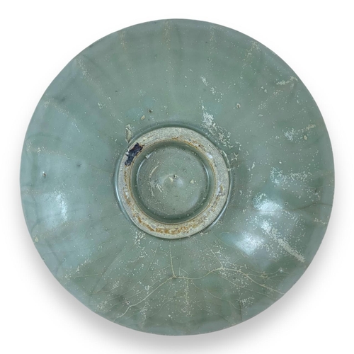 1247 - An antique Chinese Celadon Glazed porcelain Plate. Moderate wear with minor scuffs, a chipped area n... 