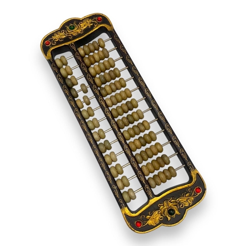 779 - An antique Chinese Jade Abacus (calculator). Hand-carved jade beads set on brass rods, framed in a w... 