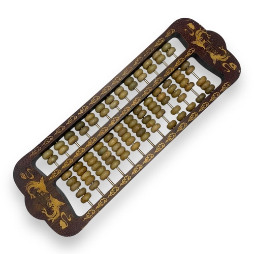 779 - An antique Chinese Jade Abacus (calculator). Hand-carved jade beads set on brass rods, framed in a w... 