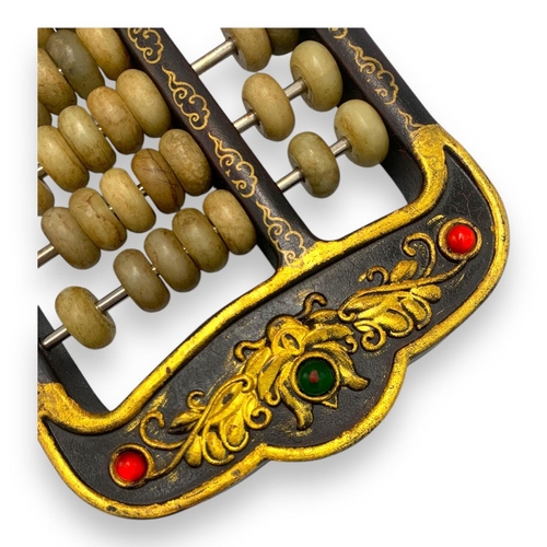 779 - An antique Chinese Jade Abacus (calculator). Hand-carved jade beads set on brass rods, framed in a w... 