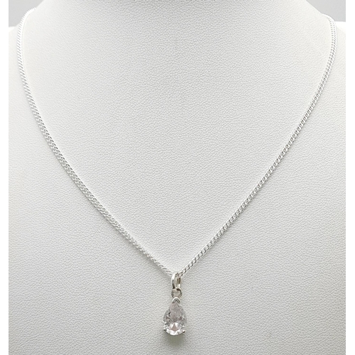 1244 - A Sterling Silver CZ Pendant on a Sterling Silver Chain. 1cm and 48cm.