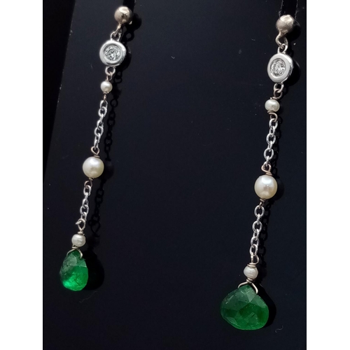 323 - A PAIR OF EMERALD AND SEED PEARL DROP EARRINGS IN 9K WHITE GOLD .         1.5gms