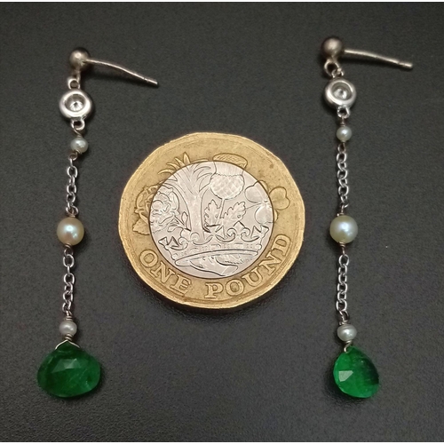 323 - A PAIR OF EMERALD AND SEED PEARL DROP EARRINGS IN 9K WHITE GOLD .         1.5gms