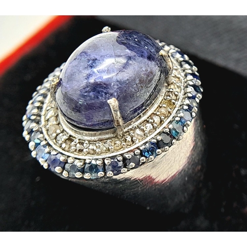 618 - An 8ct Tanzanite Gemstone Ring with 0.95ctw of Blue Sapphire Surround. Set in 925 Silver, Diamond we... 