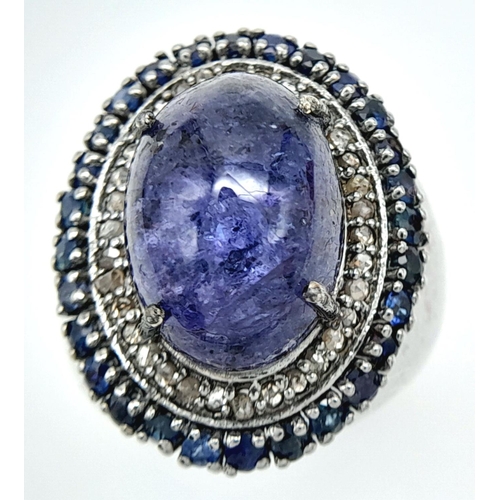 618 - An 8ct Tanzanite Gemstone Ring with 0.95ctw of Blue Sapphire Surround. Set in 925 Silver, Diamond we... 