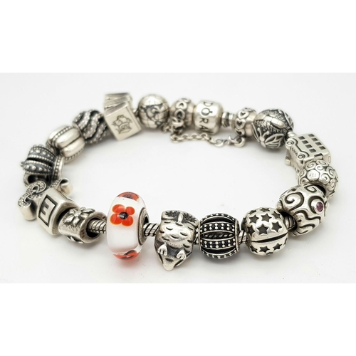 1118 - A Pandora Sterling Silver Charm Bracelet. 18 charms with multiple S25 ALE markings. 16cm. 71g