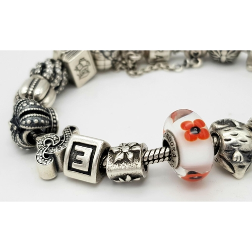 1118 - A Pandora Sterling Silver Charm Bracelet. 18 charms with multiple S25 ALE markings. 16cm. 71g