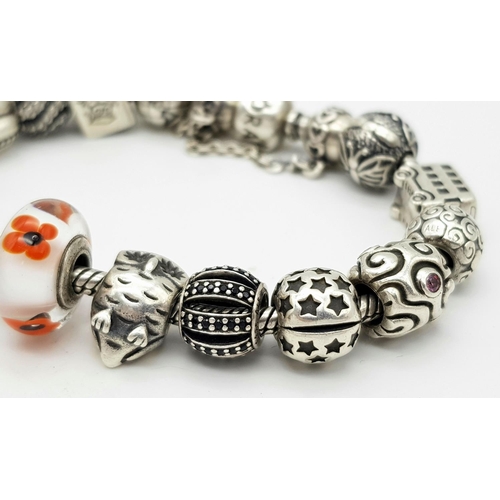 1118 - A Pandora Sterling Silver Charm Bracelet. 18 charms with multiple S25 ALE markings. 16cm. 71g