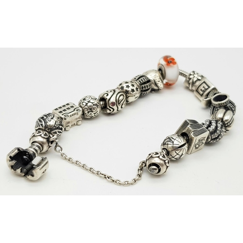 1118 - A Pandora Sterling Silver Charm Bracelet. 18 charms with multiple S25 ALE markings. 16cm. 71g