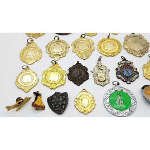 1264 - An assortment of medals, fobs, and badges.