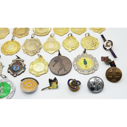 1264 - An assortment of medals, fobs, and badges.