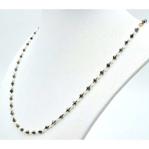 395 - AN 18K GOLD SEED PEARL AND CRYSTAL NECKLACE .   4.8gms    46cms