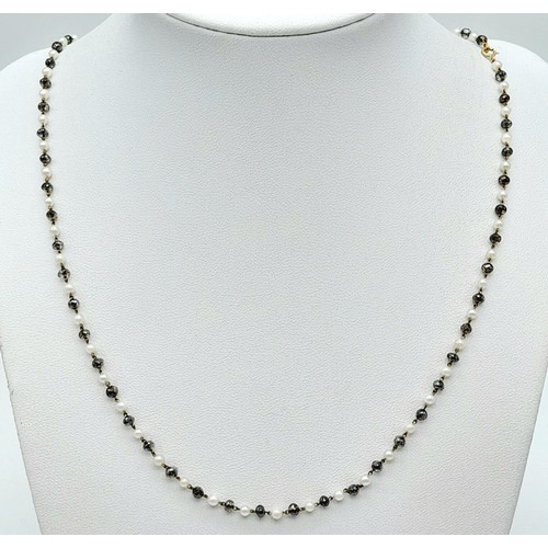 395 - AN 18K GOLD SEED PEARL AND CRYSTAL NECKLACE .   4.8gms    46cms