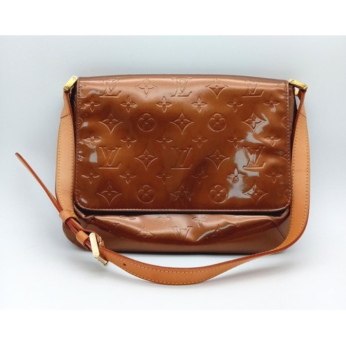 78 - A Louis Vuitton Patent Bronze Leather Handbag. LV decorative monogram exterior with gold tone hardwa... 