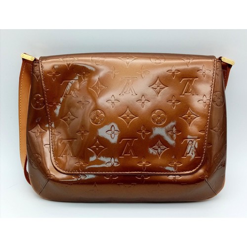 78 - A Louis Vuitton Patent Bronze Leather Handbag. LV decorative monogram exterior with gold tone hardwa... 