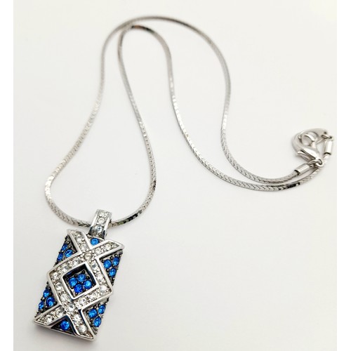 1445 - A matching set of earrings and necklace featuring blue and white stones arranged in a criss-cross pa... 