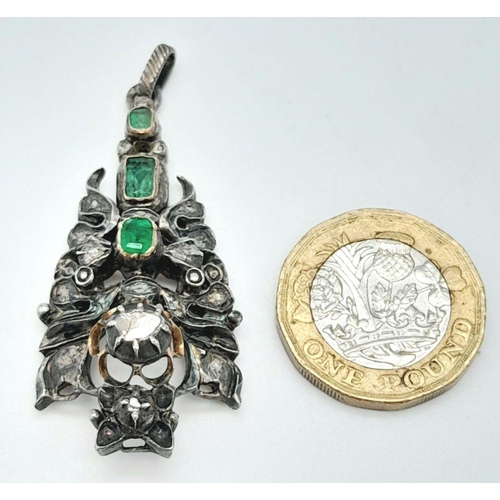 1177 - An Antique Silver Emerald and Diamond Pendant. An ornate piece with rich emeralds and old cut diamon... 