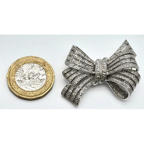 470 - A 14K White Gold and Diamond Bow Brooch. A 1.5ctw (approx) of diamond cluster excellence. 13.25g tot... 