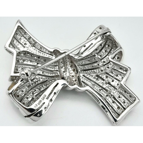 470 - A 14K White Gold and Diamond Bow Brooch. A 1.5ctw (approx) of diamond cluster excellence. 13.25g tot... 