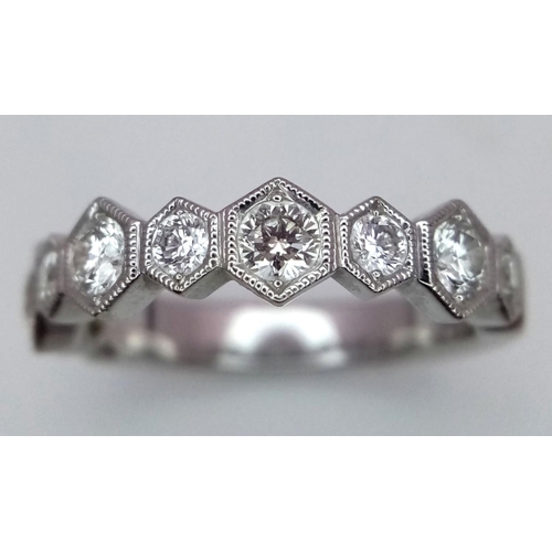 1009 - A 9K White Gold Diamond Half Eternity Ring. Hexagonal diamond links. Size L. 3.3g total weight.