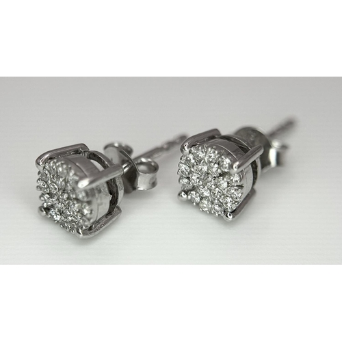 1184 - A Pair of 18K White Gold Diamond Cluster Earrings. 1.62g total weight.