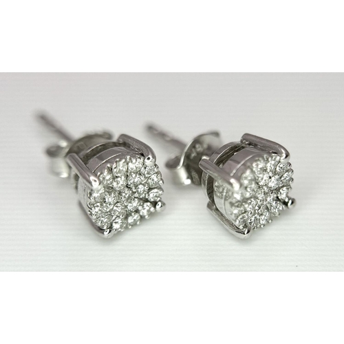 1184 - A Pair of 18K White Gold Diamond Cluster Earrings. 1.62g total weight.