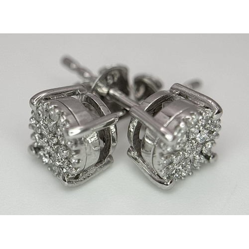 1184 - A Pair of 18K White Gold Diamond Cluster Earrings. 1.62g total weight.