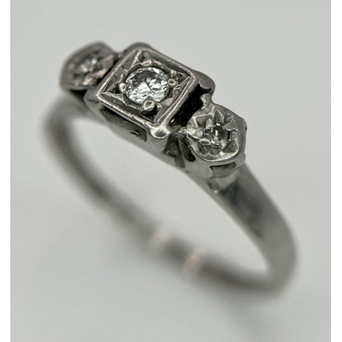 1205 - An 18K White Gold (tested) Three Stone Diamond Ring. Size N. 2.53g total weight.