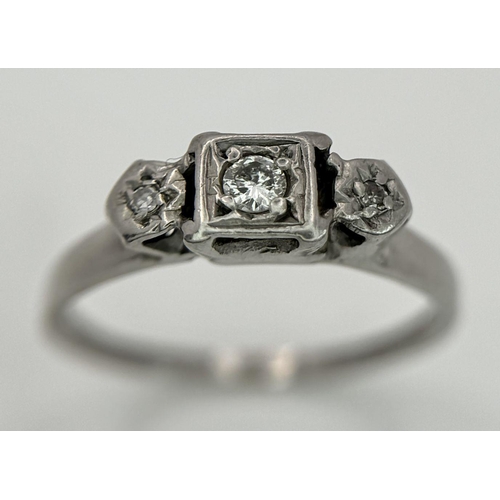 1205 - An 18K White Gold (tested) Three Stone Diamond Ring. Size N. 2.53g total weight.