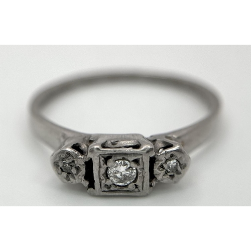 1205 - An 18K White Gold (tested) Three Stone Diamond Ring. Size N. 2.53g total weight.