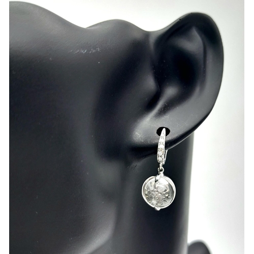 995 - A Pair of 14K White Gold, Diamond and Moonstone Cabochon Earrings. 2,5cm drop. 6.46g total weight.