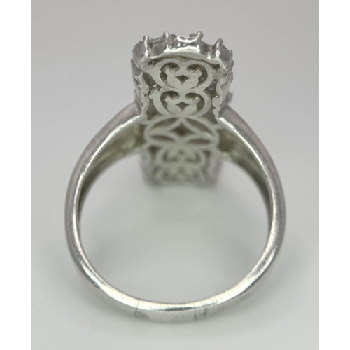 988 - A 925 Silver Diamond Cluster Ring. Elongated shape with pave diamond setting. Size T. 5.5g