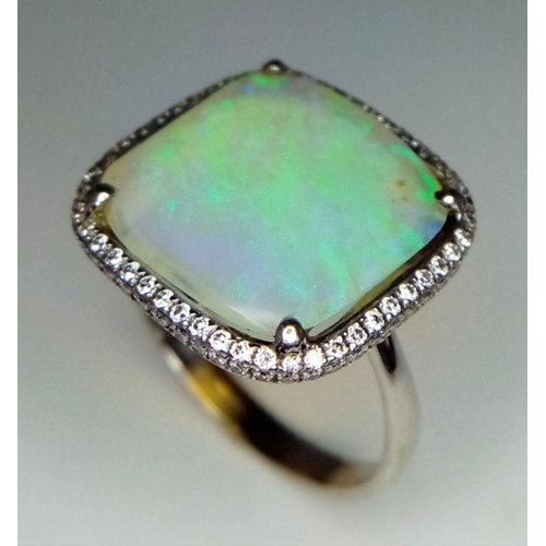 1324 - An 18K White Gold Opal and Diamond Ring. Square cut translucent opal with excellent colour-play and ... 