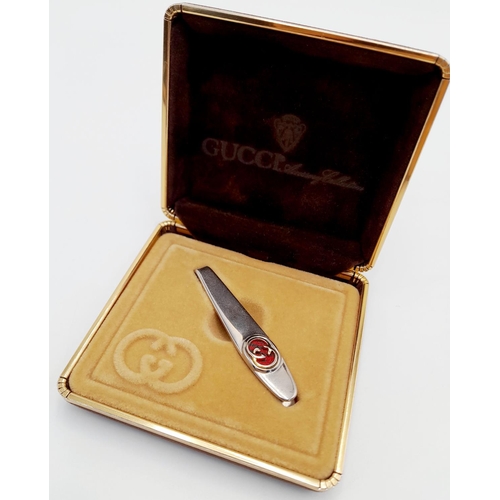 1416 - A Vintage Gucci Tie Clip. White metal with Gucci monogram. Fitted Gucci case and COA.