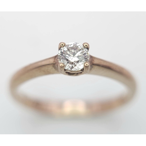 1233 - A 9K Rose Gold Diamond Solitaire Ring. 0.10ct round cut diamond. Size N. 2g total weight.