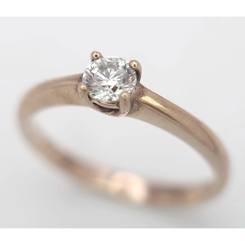 1233 - A 9K Rose Gold Diamond Solitaire Ring. 0.10ct round cut diamond. Size N. 2g total weight.