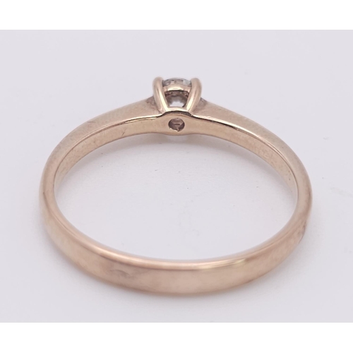 1233 - A 9K Rose Gold Diamond Solitaire Ring. 0.10ct round cut diamond. Size N. 2g total weight.