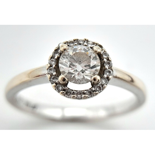 1254 - An 18K White Gold Diamond Ring. Round cut centre stone with a diamond halo. Size M, 2.93g total weig... 