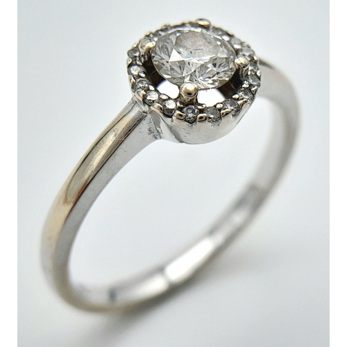 1254 - An 18K White Gold Diamond Ring. Round cut centre stone with a diamond halo. Size M, 2.93g total weig... 