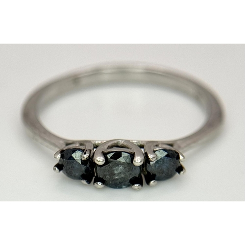 695 - A 9k White Gold Blue Diamond Trilogy Ring, 1.5g total weight, 0.40ct diamond, size N1/2.

ref: 569I